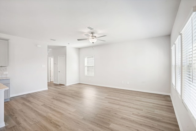 3910 Walmer Way, Princeton, TX 75071 - unfurnished living room featuring ceiling fan, light wood-style floors, and baseboards