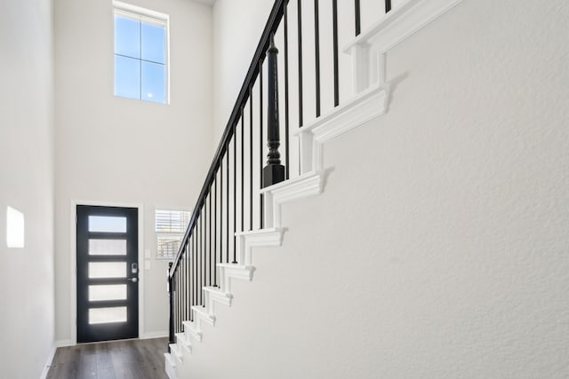 3910 Walmer Way, Princeton, TX 75071 - foyer entrance with a towering ceiling, stairway, dark wood-type flooring, and baseboards