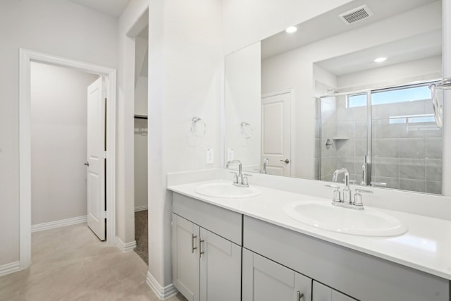 3910 Walmer Way, Princeton, TX 75071 - full bath with a shower stall, double vanity, a spacious closet, baseboards, and recessed lighting