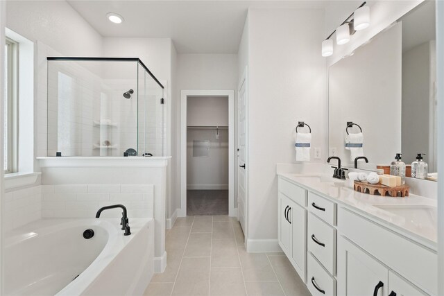 216 Freedom Trl, Forney, TX 75126 - full bathroom with a shower stall, a bath, a sink, a walk in closet, and tile patterned floors