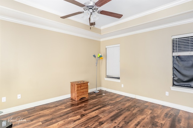 empty room featuring dark wood-style flooring, baseboards, a ceiling fan, and crown molding