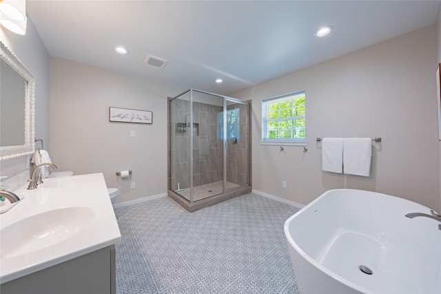 bathroom with a stall shower, a freestanding tub, and a sink