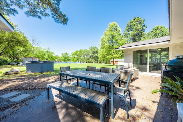 wooden deck with a yard, outdoor dining space, and a patio