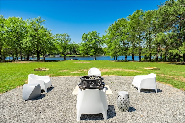 view of property's community with a yard and a water view