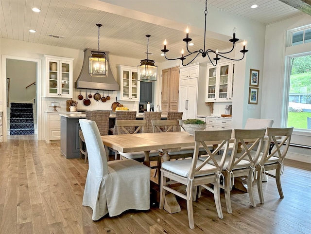 712 Camp Cypress Trl, Winnsboro, TX 75494 - dining room featuring light wood-style flooring, an inviting chandelier, and wood ceiling