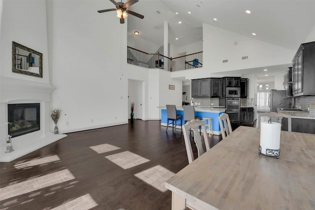 4024 Alpine Rose Ct, Roanoke, TX 76262 - dining space featuring ceiling fan, recessed lighting, dark wood finished floors, high vaulted ceiling, and a glass covered fireplace