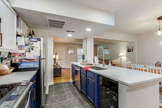 6345 Bordeaux Ave, Dallas, TX 75209 - kitchen with blue cabinetry, a sink, beverage cooler, visible vents, and appliances with stainless steel finishes