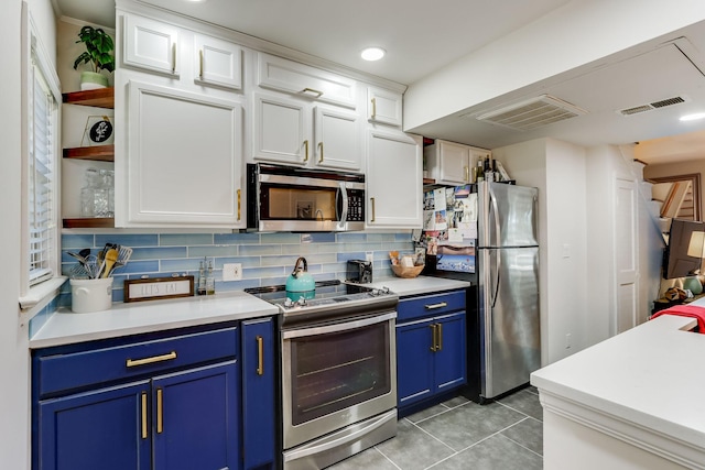 6345 Bordeaux Ave, Dallas, TX 75209 - kitchen featuring blue cabinets, visible vents, appliances with stainless steel finishes, and white cabinetry