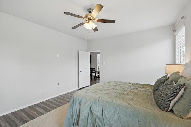 bedroom featuring wood finished floors, ceiling fan, and baseboards