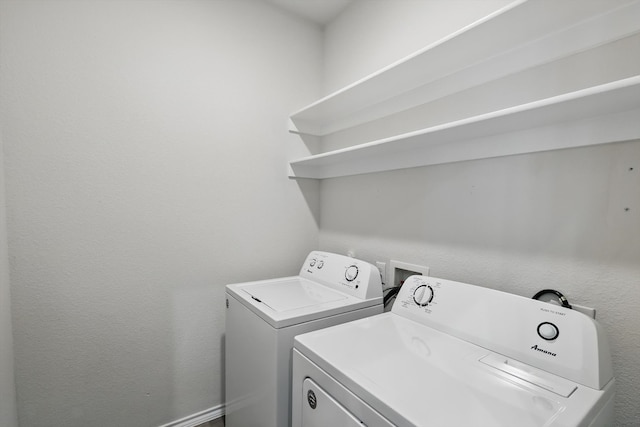 laundry area with washer and clothes dryer and laundry area