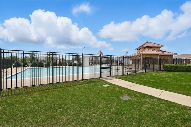 pool featuring a yard and fence