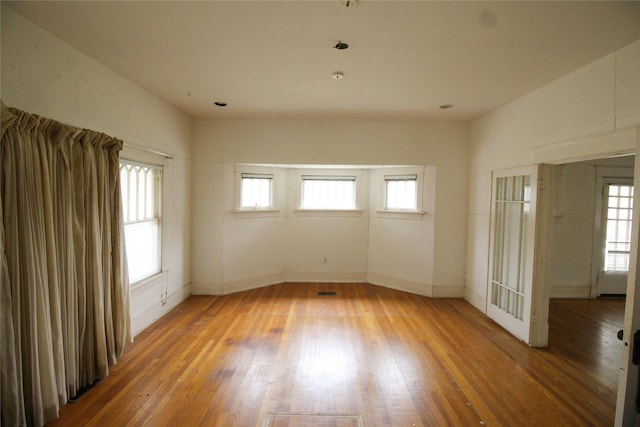 418 Merchant St, Abilene, TX 79603 - unfurnished room featuring a wealth of natural light, wood finished floors, and baseboards