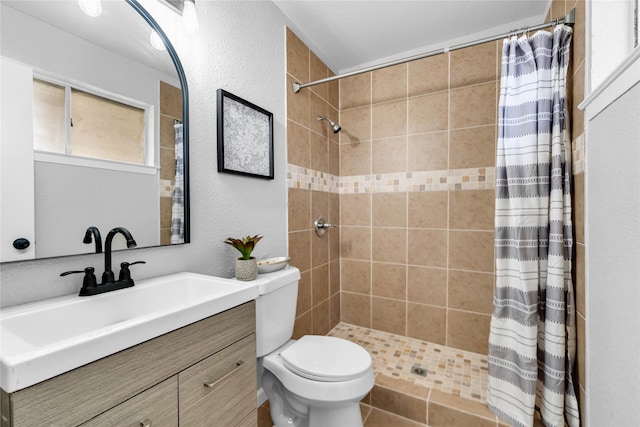 2416 Glacier St, Irving, TX 75062 - full bath featuring a tile shower, toilet, vanity, and a textured wall