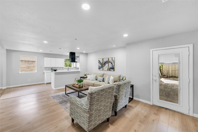 2416 Glacier St, Irving, TX 75062 - living room featuring recessed lighting, light wood-style floors, and baseboards