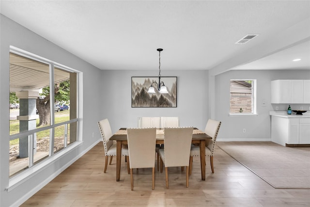 2416 Glacier St, Irving, TX 75062 - dining area featuring a chandelier, baseboards, and light wood-type flooring