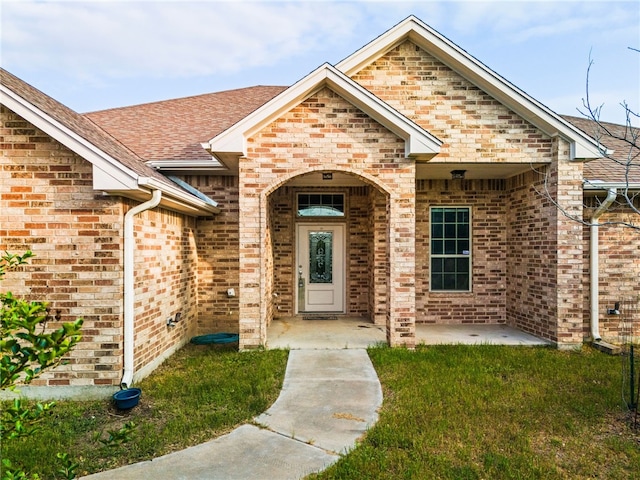 2800 Lomas Rodando Calzada, Kempner, TX 76539 - entrance to property with brick siding, a shingled roof, and a lawn