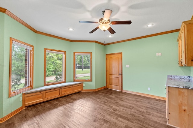 interior space featuring baseboards and wood finished floors