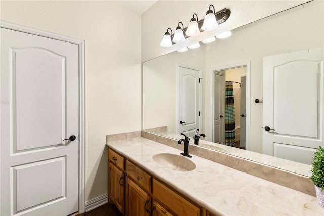 bathroom with a shower with shower curtain and vanity