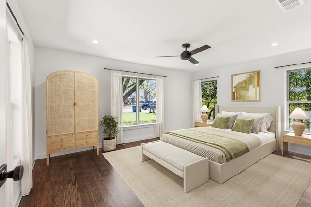 bedroom with dark wood-type flooring, visible vents, recessed lighting, and multiple windows
