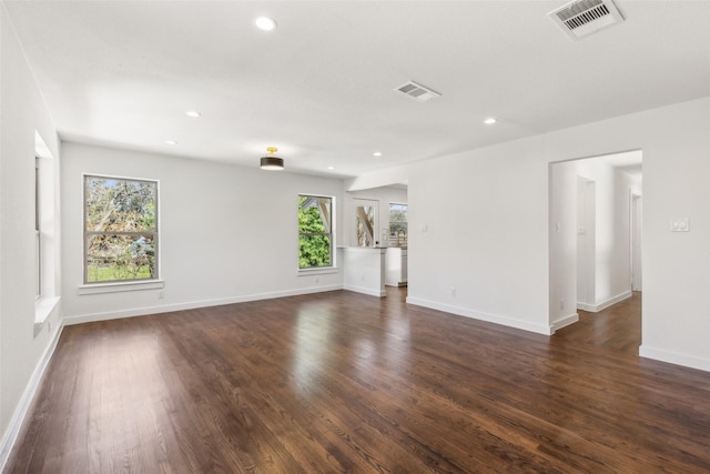 unfurnished living room featuring dark wood finished floors, visible vents, and recessed lighting