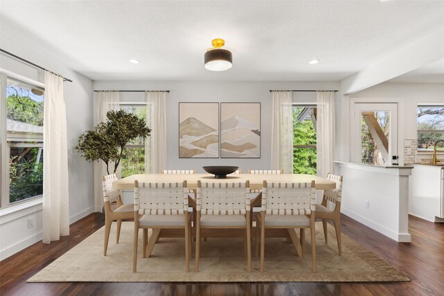 dining area with dark wood-type flooring, recessed lighting, and baseboards