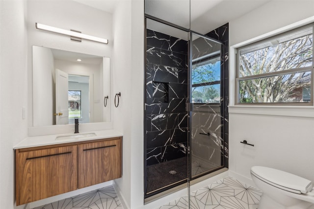 bathroom with toilet, a marble finish shower, vanity, and baseboards