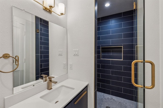 bathroom featuring a stall shower and vanity
