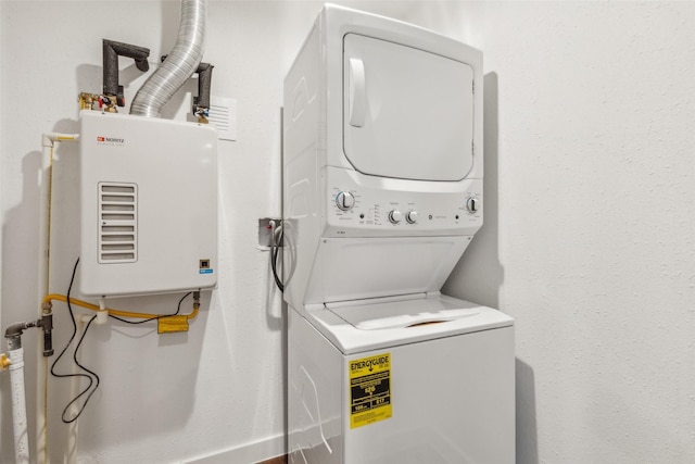 washroom with stacked washing maching and dryer and water heater