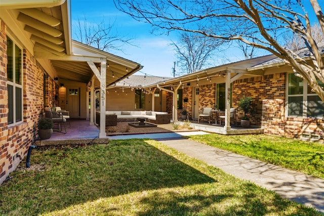 view of yard with an outdoor living space and a patio area