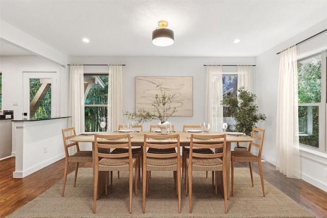 dining area featuring recessed lighting, wood finished floors, and baseboards