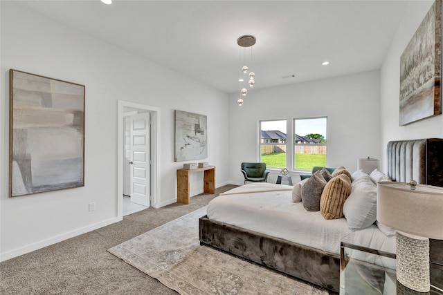 carpeted bedroom featuring baseboards and recessed lighting
