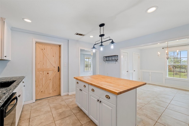 709 Verde Dr, Burleson, TX 76028 - kitchen featuring wood counters, a notable chandelier, visible vents, decorative light fixtures, and dishwashing machine