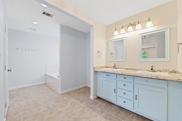 709 Verde Dr, Burleson, TX 76028 - bathroom featuring a garden tub, double vanity, a sink, and visible vents