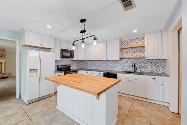 709 Verde Dr, Burleson, TX 76028 - kitchen with white cabinets, black appliances, butcher block counters, and a sink