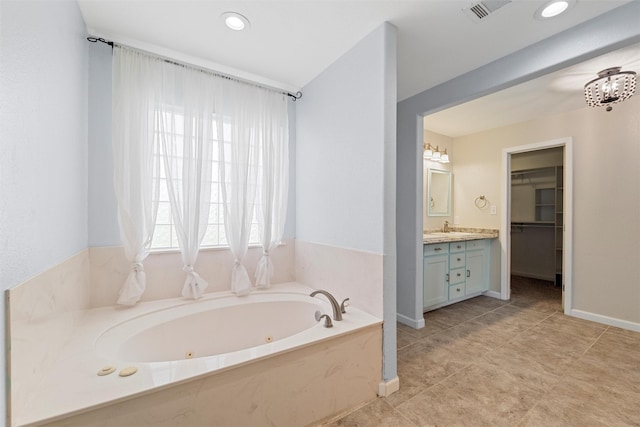709 Verde Dr, Burleson, TX 76028 - bathroom with recessed lighting, vanity, a whirlpool tub, visible vents, and a spacious closet