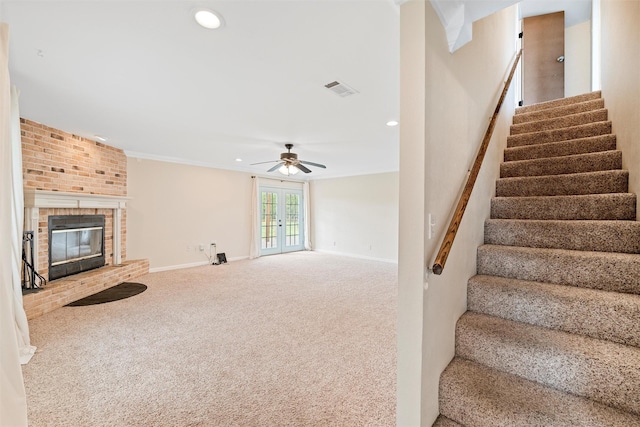 709 Verde Dr, Burleson, TX 76028 - stairway with carpet flooring, a fireplace, a ceiling fan, visible vents, and baseboards