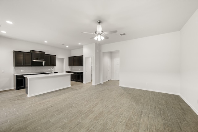 2608 Streamside Dr, Burleson, TX 76028 - kitchen with light wood-style floors, open floor plan, ceiling fan, decorative backsplash, and recessed lighting