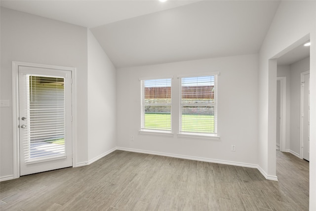 2608 Streamside Dr, Burleson, TX 76028 - spare room featuring light wood-style flooring and vaulted ceiling