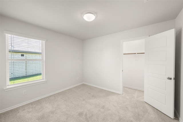 2608 Streamside Dr, Burleson, TX 76028 - unfurnished bedroom featuring multiple windows, light colored carpet, a spacious closet, and a closet