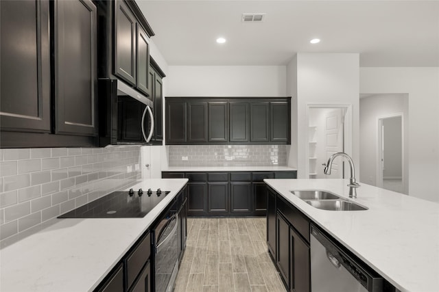 2608 Streamside Dr, Burleson, TX 76028 - kitchen featuring appliances with stainless steel finishes, backsplash, light stone counters, light wood finished floors, and recessed lighting