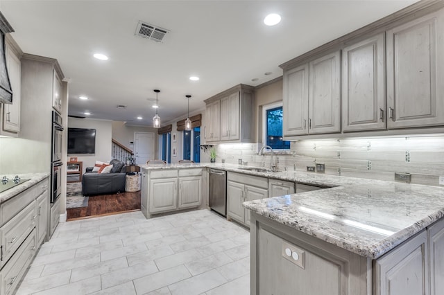kitchen with a sink, a peninsula, open floor plan, stainless steel appliances, and visible vents