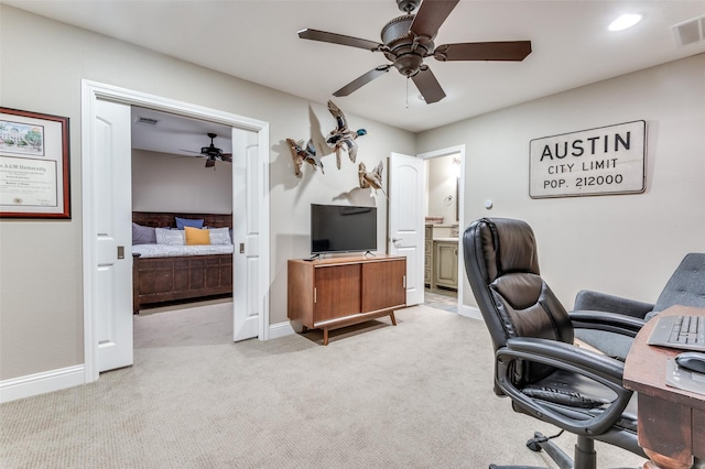 office space featuring baseboards, carpet flooring, ceiling fan, and visible vents