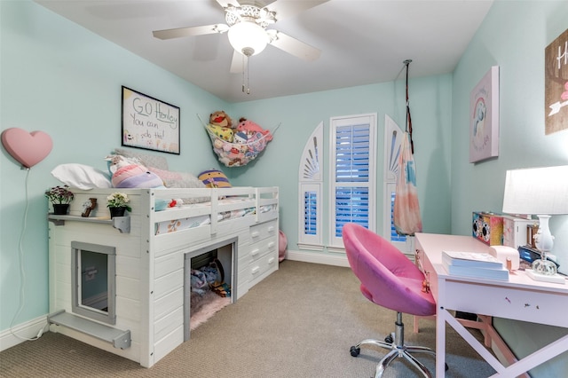 carpeted bedroom featuring baseboards, a fireplace, and a ceiling fan