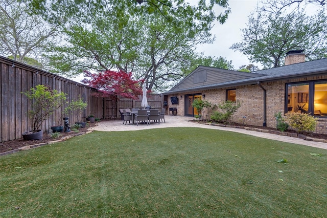 view of yard with a fenced backyard and a patio