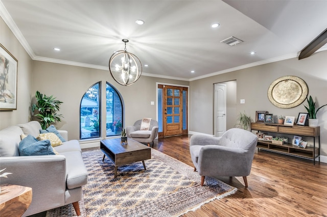 living room with ornamental molding, wood finished floors, an inviting chandelier, and recessed lighting