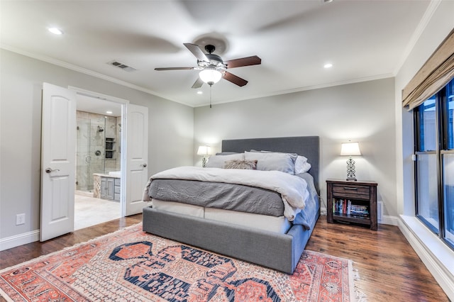 bedroom featuring visible vents, wood finished floors, and ornamental molding
