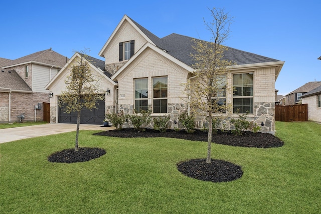 3644 Platte River Trl, Prosper, TX 75078 - view of front facade with fence, stone siding, a front lawn, concrete driveway, and an attached garage