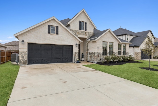 3644 Platte River Trl, Prosper, TX 75078 - view of front of home featuring a front lawn, driveway, stone siding, and central AC