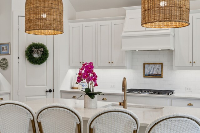 3644 Platte River Trl, Prosper, TX 75078 - kitchen featuring white cabinets, stainless steel gas stovetop, decorative backsplash, and light countertops