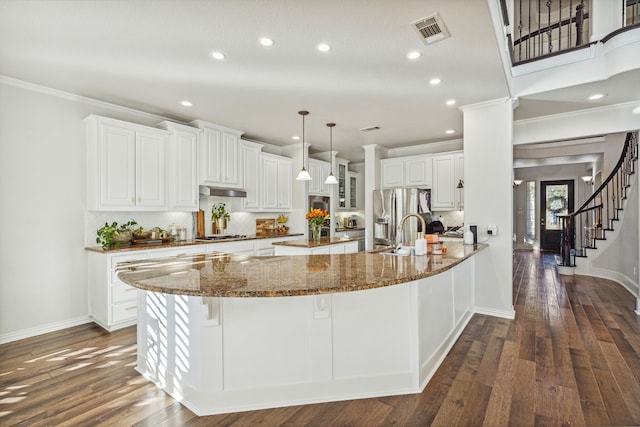 8105 Ryder Ct, Mckinney, TX 75072 - traditional home featuring an attached garage, stone siding, a shingled roof, and covered porch